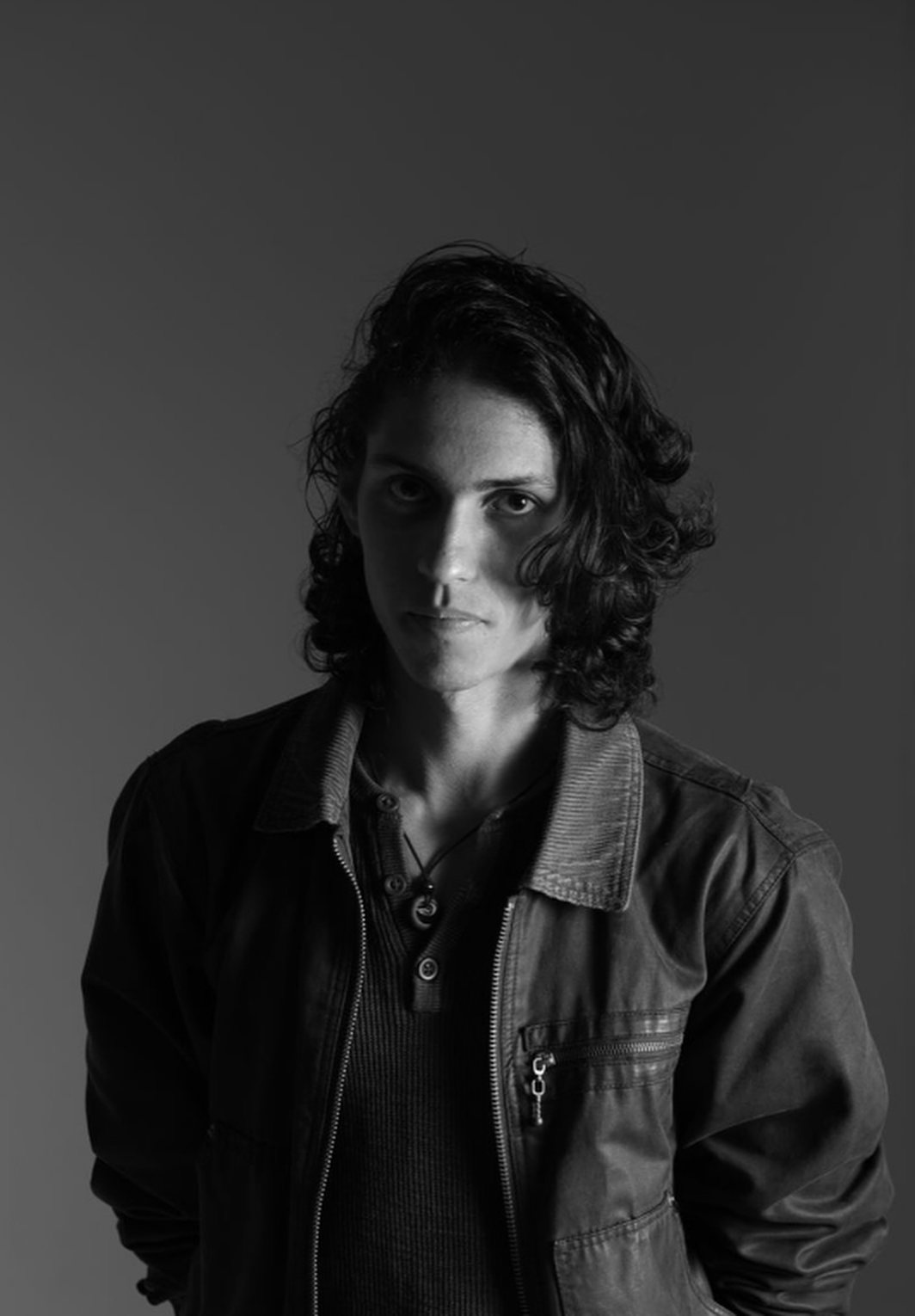 Black and white portrait of Brayan in a leather jacket