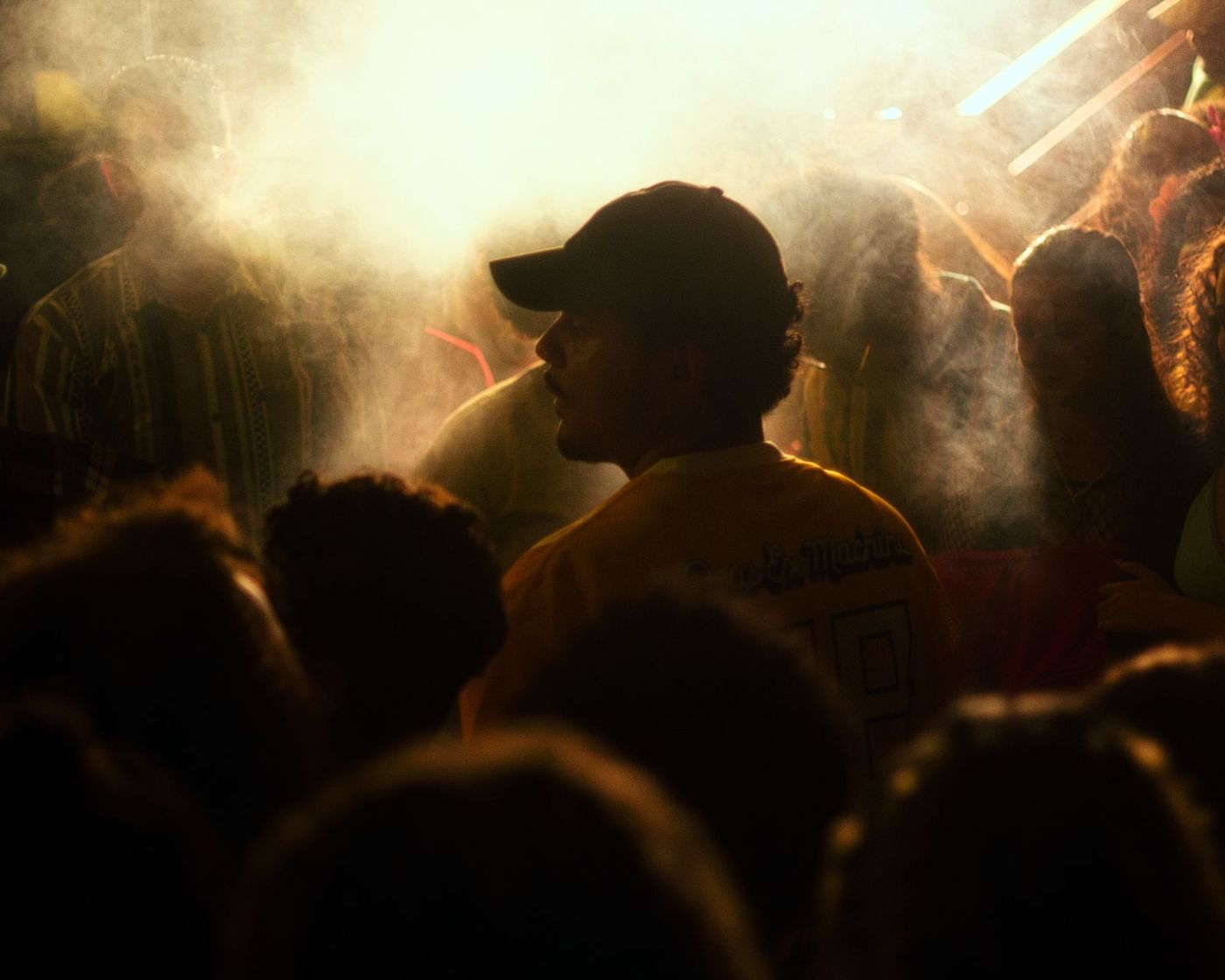 Man in a cap in the smoke of the dance floor