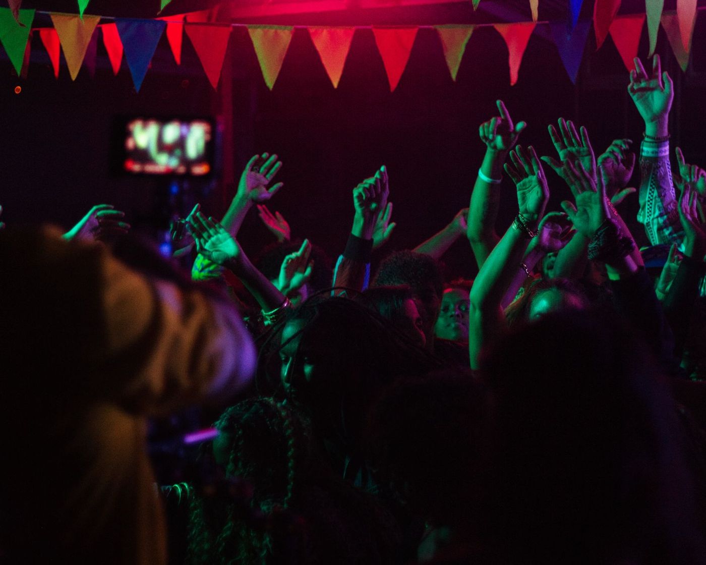 Crowd hands in red and green light