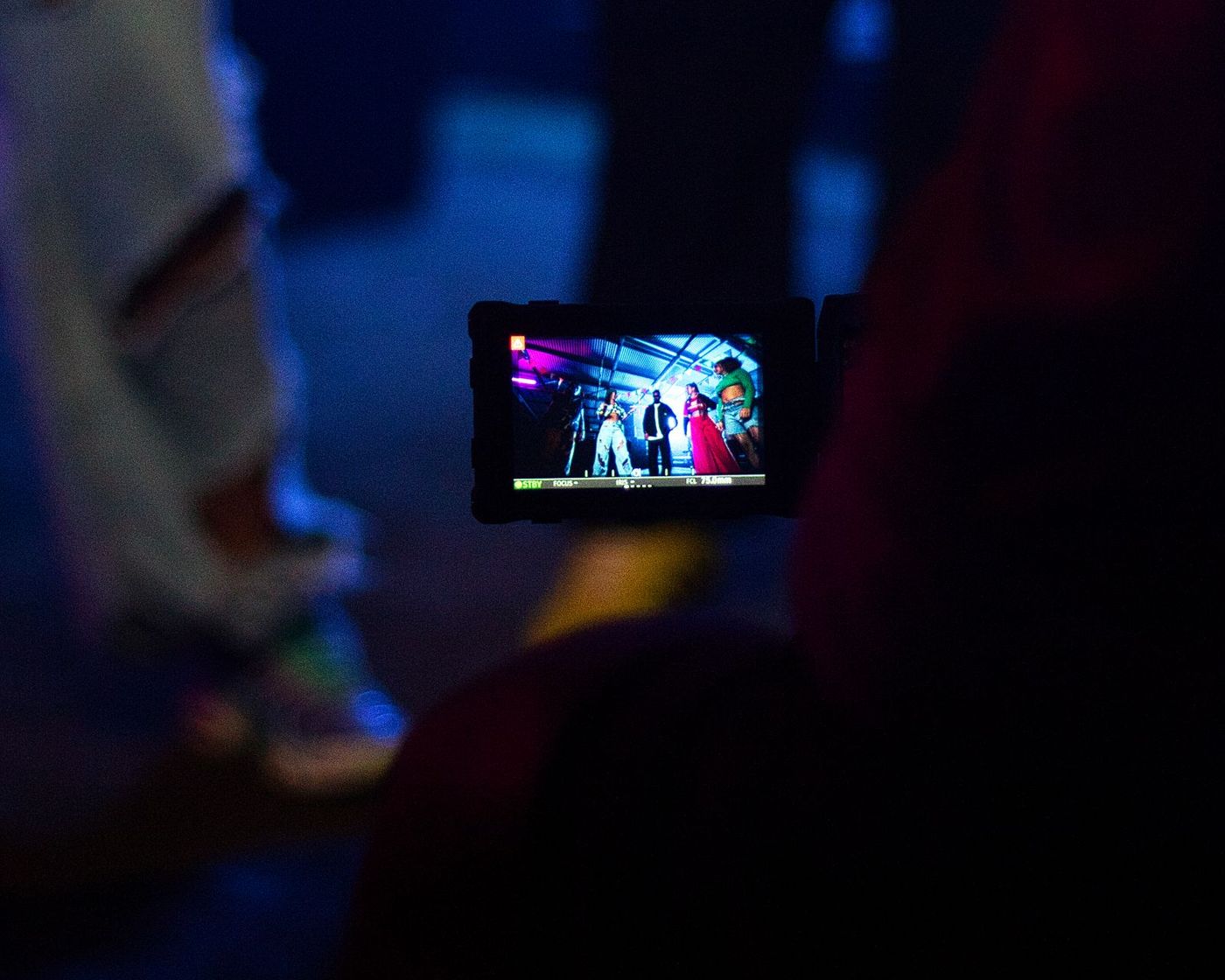 A phone filming the stage from inside the crowd