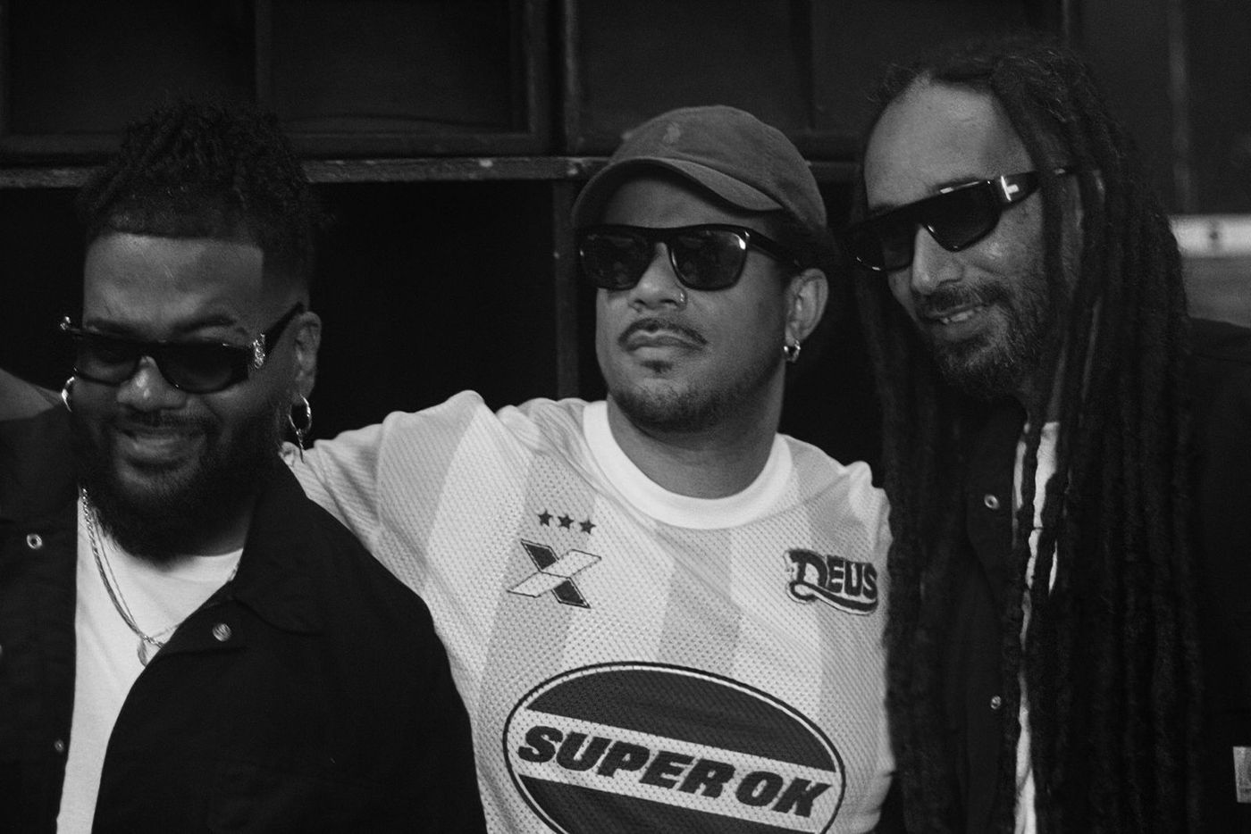 Black and white portrait of three men in sunglasses