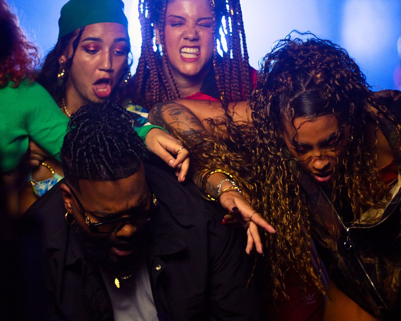 Dancers mid-song in blue and red light