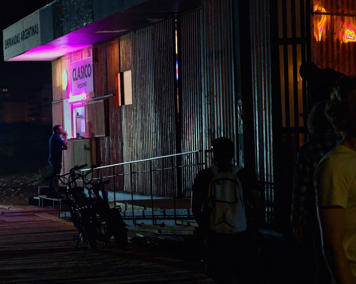 Pink neon glow in a dark alley